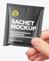 Glossy Sachet in a Hand Mockup