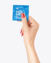 Glossy Square Condom Packaging in a Hand Mockup