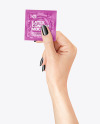 Glossy Square Condom Packaging in a Hand Mockup