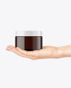 Amber Glass Cosmetic Jar in a Hand Mockup