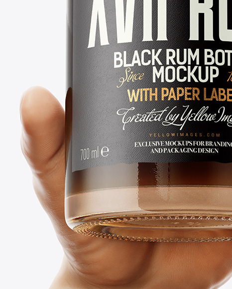 Black Rum Bottle in the Hand Mockup