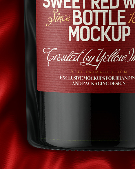 Green Glass Red Wine Bottle Lying on a Silk Cloth Mockup