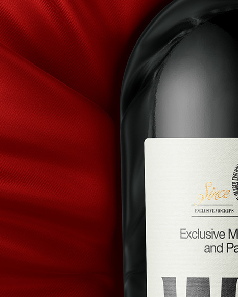 Green Glass Red Wine Bottle Lying on a Silk Cloth Mockup
