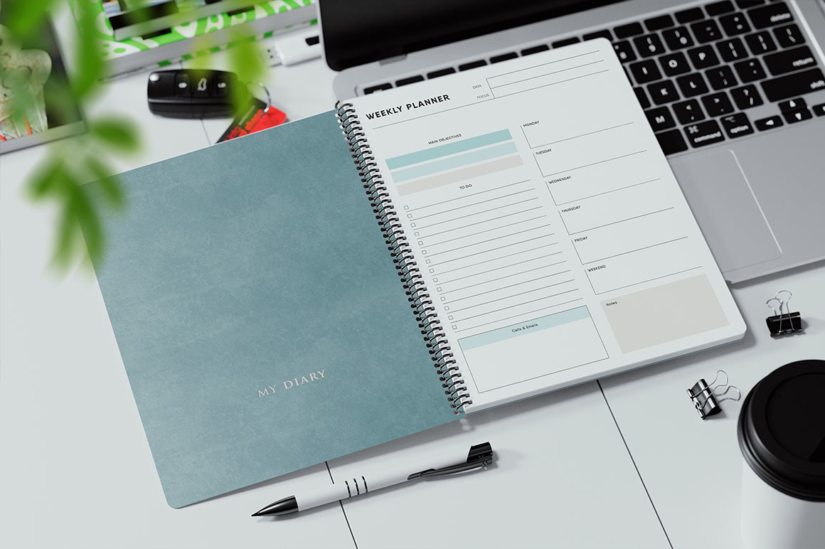 Coil Bound Book on a Laptop Keyboard Mockup Coil Bound Book on a Laptop Keyboard Mockup