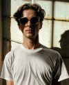 Male Model Wearing a T-Shirt and Sunglasses Mockup