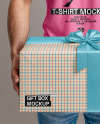 Bearded Man Wearing a Tight Fit T-Shirt Holds a Gift Box Mockup