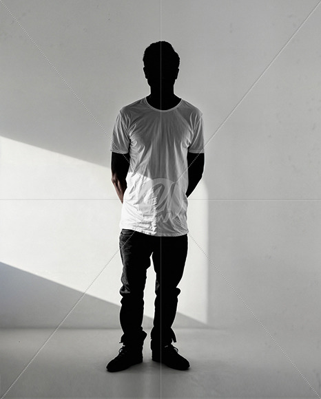 Black Man Wearing a T-Shirt Stands in a White Room Mockup