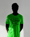 Black Man Wearing a T-Shirt Stands in a White Room Mockup