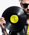 Man with Vinyl Record Wearing a Leather Jacket and T-Shirt Mockup
