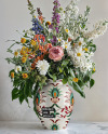 Glossy Ceramic Vase with a Bouquet of Flowers Mockup