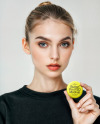 Woman Holding Round Button Pin in a Hand Mockup