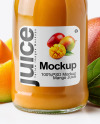 A Bottle of Mango Juice with Mango Pieces and Green Leafs Mockup