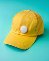 Round Button Pin on a Yellow Baseball Cap Mockup