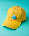 Round Button Pin on a Yellow Baseball Cap Mockup