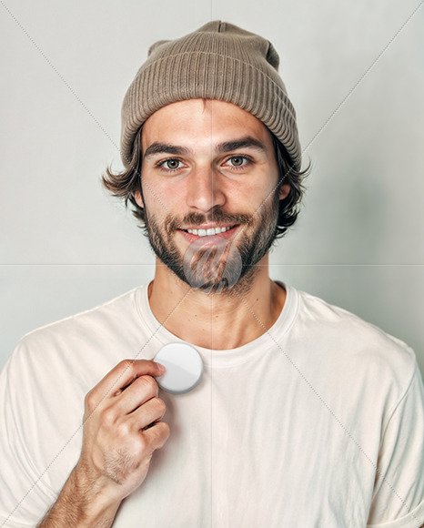 Man Wearing a T-Shirt and Beanie Hat Holding a Button Pin Mockup