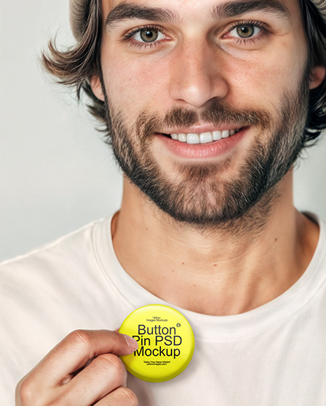 Man Wearing a T-Shirt and Beanie Hat Holding a Button Pin Mockup