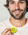 Man Wearing a T-Shirt and Beanie Hat Holding a Button Pin Mockup