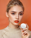 Young Woman Holding a Pin-Back Button Mockup