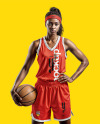 Female Basketball Player Wearing a V-Neck Jersey and Shorts Mockup