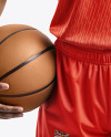 Woman Wearing a V-Neck Basketball Jersey and Shorts with a Ball Mockup