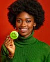 Black Woman Holding a Pin-Back Button Mockup