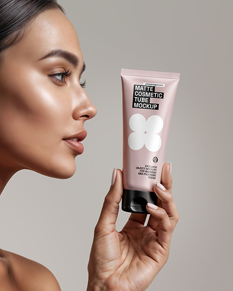 Woman Holding Cosmetic Tube in a Hand Mockup