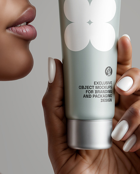 Black Woman Holding Cosmetic Tube in a Hand Mockup