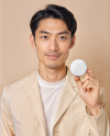 An Asian Man Holding a Button Pin Mockup