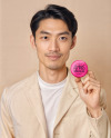 An Asian Man Holding a Button Pin Mockup