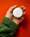Female Hand Holding a Pin-Back Button Mockup