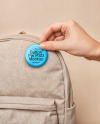 Hand Putting a Button Pin on a Backpack Mockup