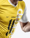 A Running Soccer Player Wearing a V-Neck Jersey and Shorts Mockup
