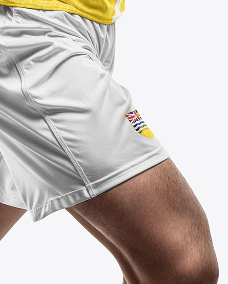 A Running Soccer Player Wearing a V-Neck Jersey and Shorts Mockup