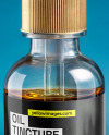 Oil Tincture Dropper Bottle with Herbs and Blue Background Mockup