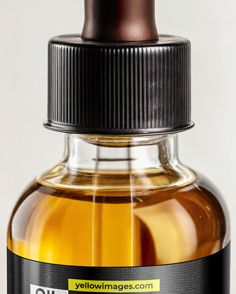Oil Tincture Dropper Bottle on a Wooden Plate with Herbs Mockup