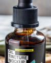 Amber Dropper with Oil Tincture on a Wooden Plate with Dry Herbs Mockup