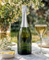 Green Glass Champagne Bottle on a Tablecloth Mockup