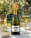 Green Glass Champagne Bottle on a Tablecloth Mockup