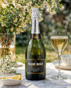 Green Glass Champagne Bottle on a Tablecloth Mockup