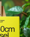 Wooden Easel with Canvas and Green Plants on Background Mockup