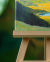 Wooden Easel with Canvas and Green Plants on Background Mockup