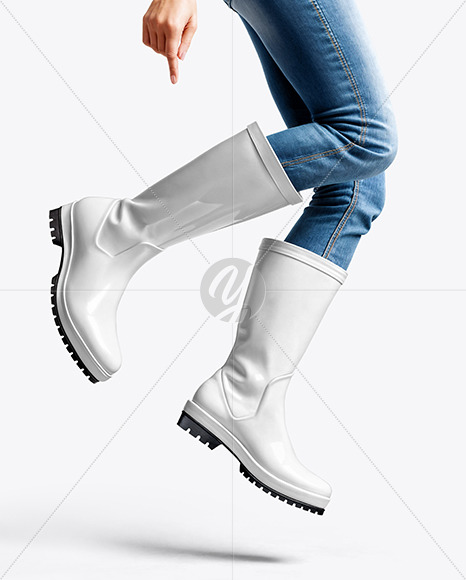 Rain Boots on Jumping Women's Legs with Jeans Mock
