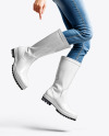 Rain Boots on Jumping Women's Legs with Jeans Mock
