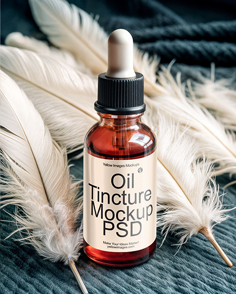 Ruby Oil Tincture Dropper Bottle with Feathers on Fabric Mockup