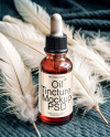 Ruby Oil Tincture Dropper Bottle with Feathers on Fabric Mockup