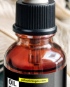 Ruby Oil Tincture Dropper Bottle with Feathers on Fabric Mockup