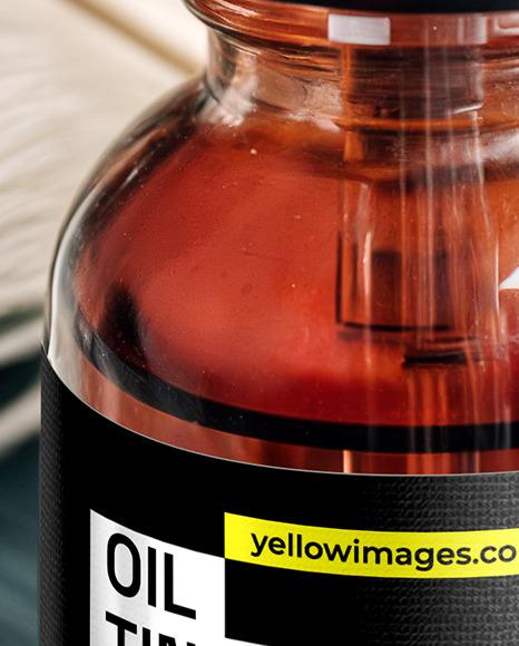 Ruby Oil Tincture Dropper Bottle with Feathers on Fabric Mockup