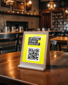 Plastic QR Code Scan Stand on a Wooden Table Mockup