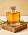 Orange Oil Tincture Square Bottle on a Wooden Board with Herbs Mockup