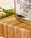 Orange Oil Tincture Square Bottle on a Wooden Board with Herbs Mockup
